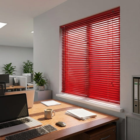 Modern office with a desk, laptop, and red blinds on a window.