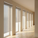Custom manufactured grey-white 3% sheer roller blinds along passage